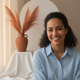 Headshot portrait of a smiling woman in her mid-30s, conveying satisfaction and trust.